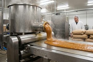 Baking chocolate supplier Iran inspecting industrial toffee production